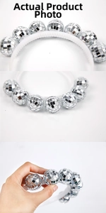Detail of silver disco mirror balls on white headband showing reflective mosaic texture