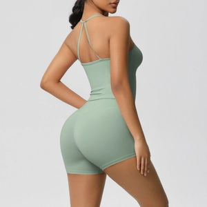 Detail of mint green yoga set featuring a cross back sports tank and high waist shorts