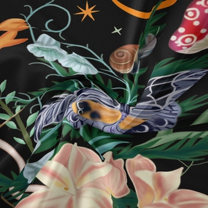 Close-up of floral tapestry fabric with snail and moth patterns in deep colors
