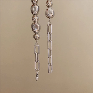Detailed close-up of French irregular silver beads and rectangle link chain necklace