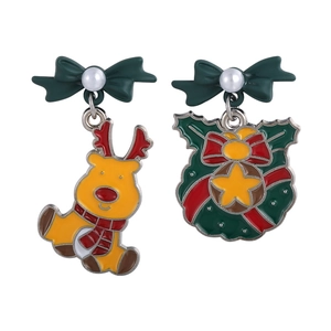 Close-up of asymmetric Christmas stud earrings with enamel reindeer and festive wreath