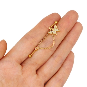 Detailed view of a gold butterfly industrial barbell earring with chains and zircons