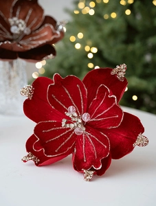 Macro shot of red velvet Christmas flower decoration with gold glitter and bead details