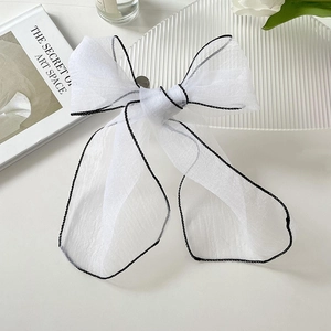 Elegant white organza scarf with black trim tied in a bow for hair or neck styling