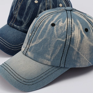 Vintage washed denim baseball cap featuring bleached snowflake texture and contrast stitching