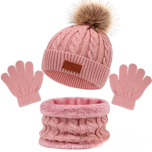 Detailed set of pink knitted hat with faux fur pom, cozy scarf, and warm gloves