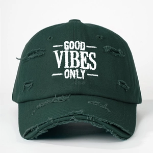 Detail of distressed dark green baseball cap with white Good Vibes Only embroidery