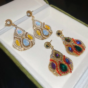Detailed macro view of vintage droplet earrings with colorful crystals in a gift box
