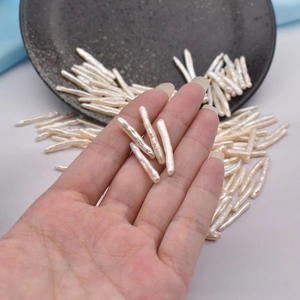 Macro shot of natural Baroque toothpick pearls showing unique texture and long bar shape