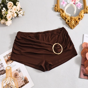 Detail view of dark brown ruched hot pants with golden metal ring decor on side