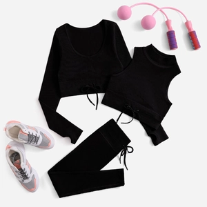 Three-piece black ribbed yoga set with long sleeve crop top, vest and high waist leggings