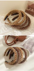 Detailed close-up of leopard print headband set with soft velvet texture and handmade label