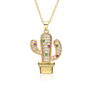 Detailed view of a gold plated cactus pendant with vibrant green and red cubic zirconia
