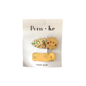 Sparkly gold sequins bow hair clip with a smiling sun charm for girls and kids