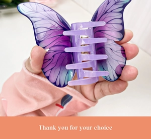 Detailed macro view of purple butterfly hair claw clip with elegant gradient wing pattern