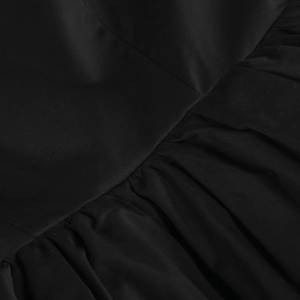 Detailed close-up of high-quality black satin fabric featuring fine pleated texture