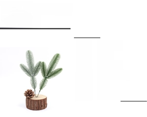 Detailed view of artificial pine needles with a natural pine cone on a rustic wood base