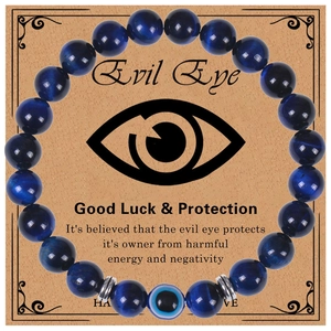 Detailed macro view of Evil Eye charm bracelet with blue tiger eye beads and silver spacers