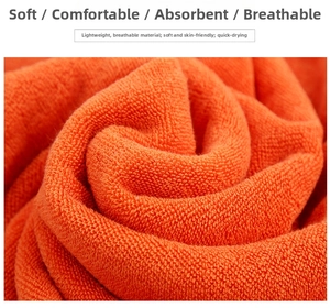 Close-up of orange absorbent microfiber towel fabric with soft breathable texture