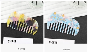 Close-up of cute cat-shaped acetate hair combs in marble yellow and blue patterns