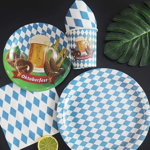 Flat lay of Oktoberfest party set with blue diamond pattern paper plates and cups