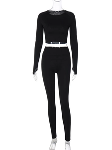 Close-up of black two-piece yoga set with long sleeve crop top and high waist leggings