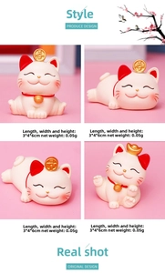 Detail view of four miniature white Maneki Neko cat figurines for home decoration