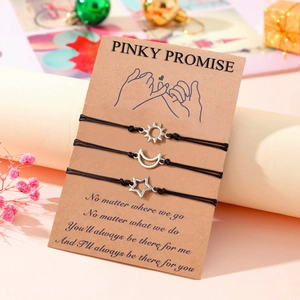 Black braided rope sun moon star friendship bracelets set on a pinky promise card