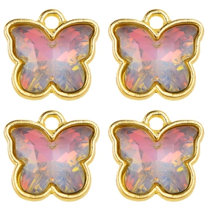 Macro detail of pink butterfly charms with gold metal frames and faceted resin centers