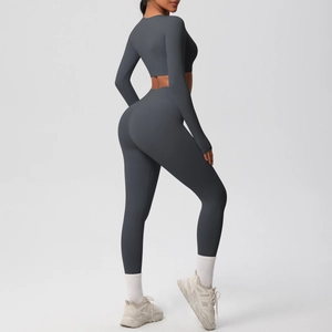 Detail of grey long sleeve crop top and high waist yoga leggings on model side view