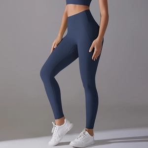 Detailed close-up showing the high-waisted fit and sculpting fabric of navy yoga leggings