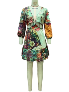 Detail of waist cut-out with metal ring connector on a landscape print dress