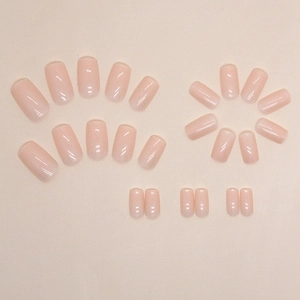 Set of 24 glossy nude pink short square press-on nails displayed in a circular layout