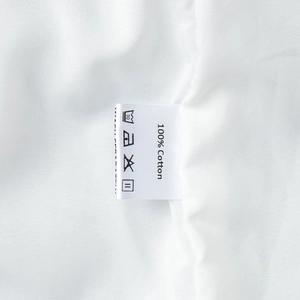 Detail shot of the 100% cotton fabric and garment care label on the white skirt set