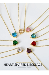 Macro shot of heart-shaped zircon pendants in multiple vibrant colors on gold chains