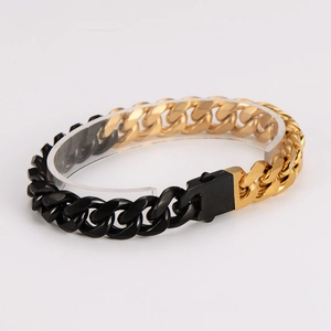 Detailed view of two-tone gold and black cuban link bracelet with a mechanical clasp