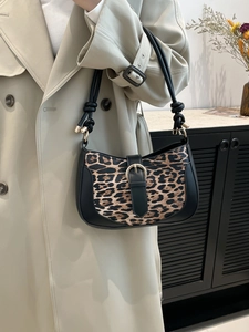 Fashionable leopard print underarm bag with black leather stitching and metal buckle