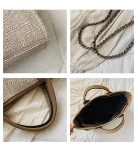 Detail of beige woven tote bag showing stitching, chain strap, and inner zipper pocket
