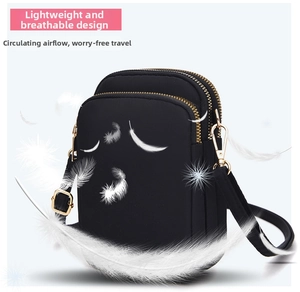 Detailed view of lightweight black nylon crossbody phone bag with three zipper compartments