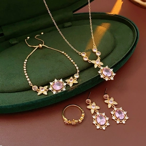 Exquisite vintage jewelry set with pink stones in a dark green velvet display box