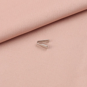 Macro shot of silver stainless steel fold-over cord end crimp for jewelry making