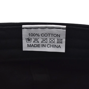 Detailed view of the 100% cotton wash care label inside a black Boston baseball cap