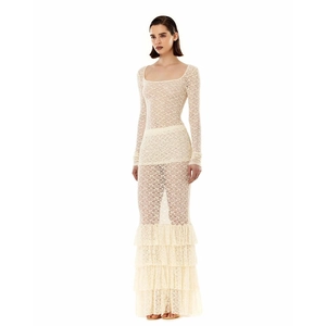 Detail of cream lace two-piece set featuring long sleeves and tiered ruffle maxi skirt