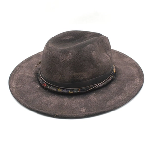 Detail of vintage wool fedora with distressed texture, floral band, and leather cord