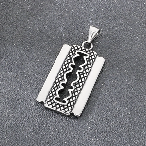 Macro shot of silver stainless steel razor blade pendant with industrial punk texture