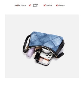 Internal view of blue denim shoulder bag showing phone, lipstick and cosmetics capacity