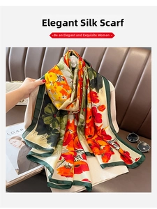 Detail of floral print silk scarf with green edges, styled with sunglasses and handbag