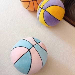 Plush basketball throw pillows in orange, purple, and pink soft fleece fabrics