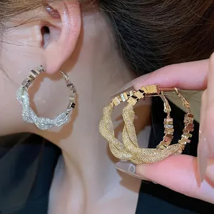 Silver needle hoop earrings with twisted metal texture and micro-paved zircons