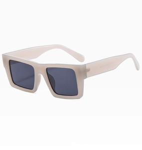 Detail view of cream oversized square frame sunglasses with dark grey lenses and specs